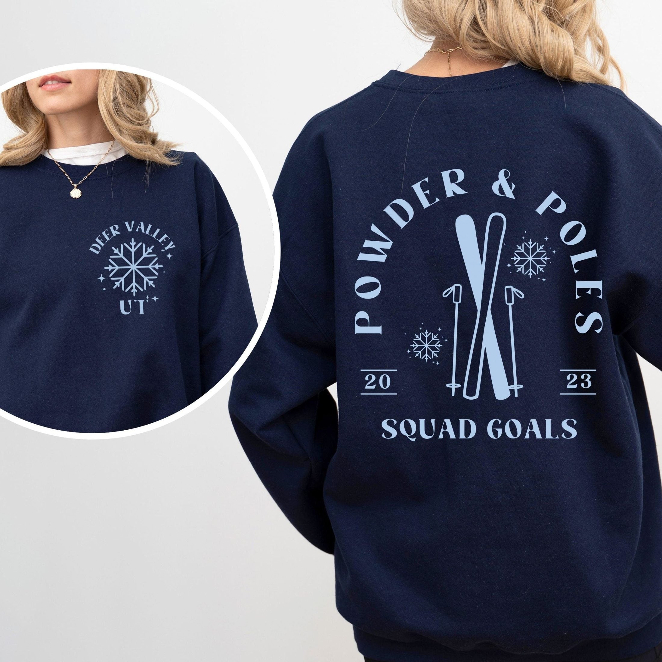 Woman wearing custom matching group girls ski trip sweatshirt with powder and poles design on navy crewneck