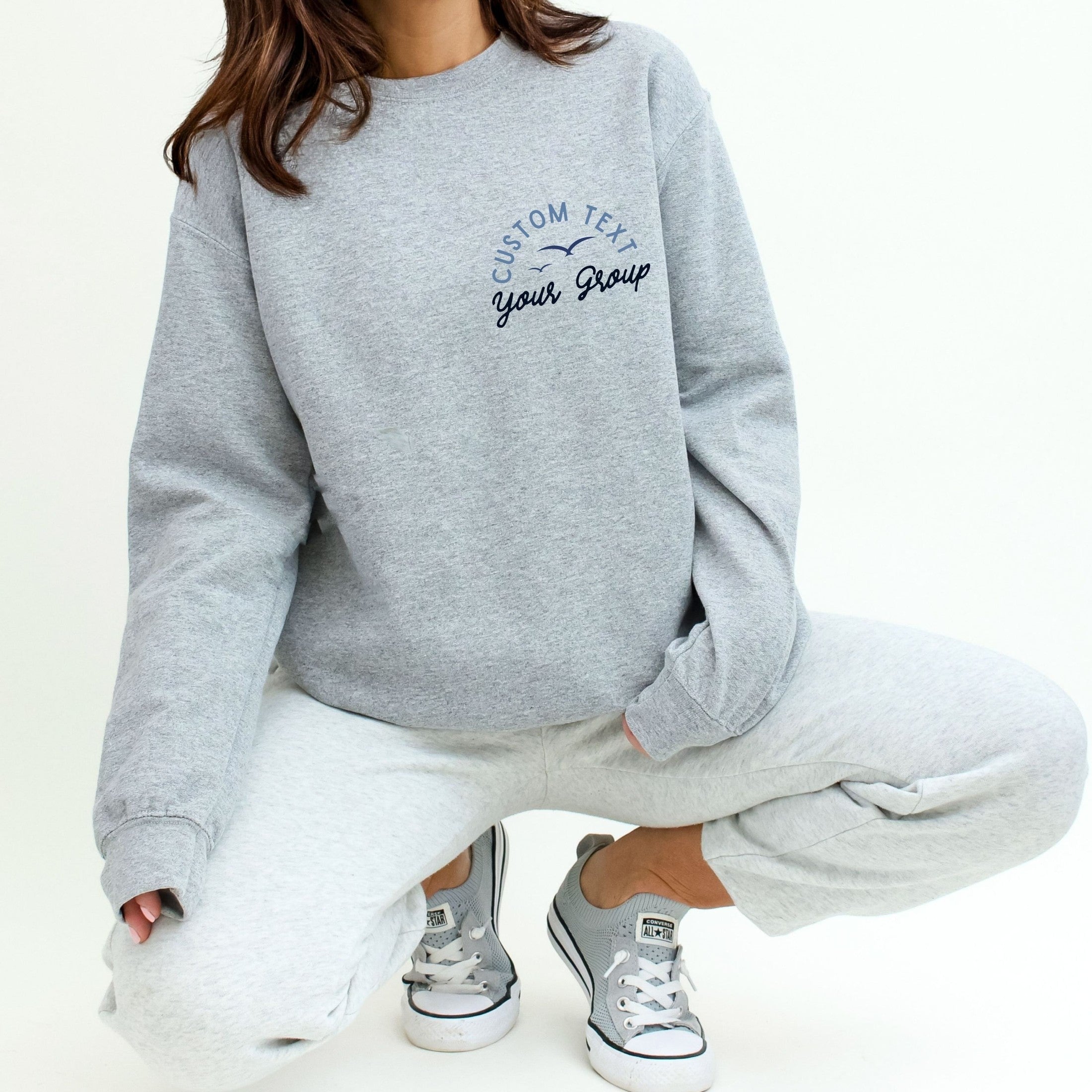 Woman wearing custom matching family Lake Is My Happy Place shirts personalized with name and year. Perfect for group lake vacations, shown on gray crewneck sweatshirt