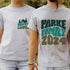Girl wearing custom matching family adventure vacation shirt with green retro style Happy Camper design. Perfect for group camping trips. Shown on gray tshirt.