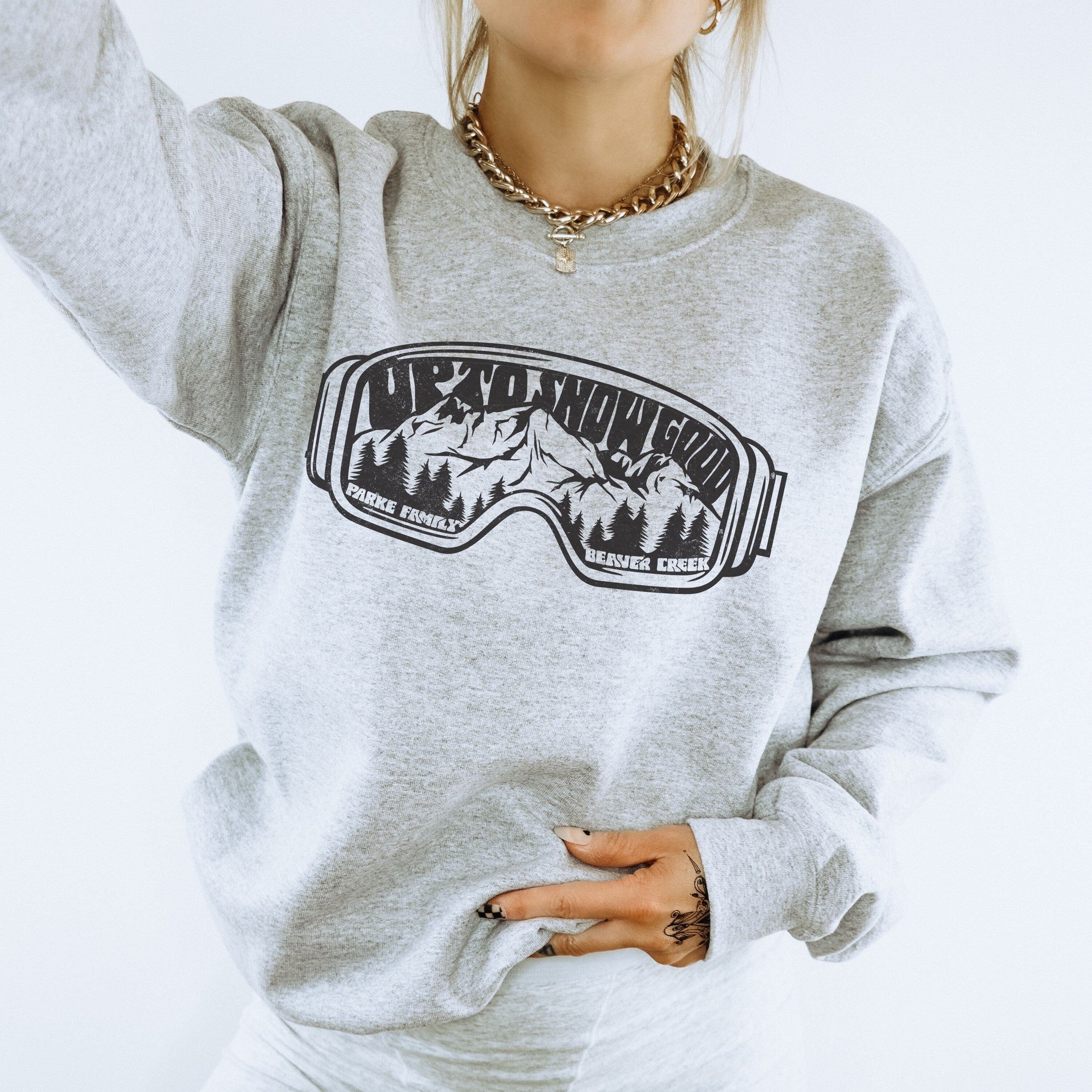 woman wearing Custom matching family ski trip sweatshirt with funny Up To Snow Good goggles design for group mountain weekend vacations shown in gray