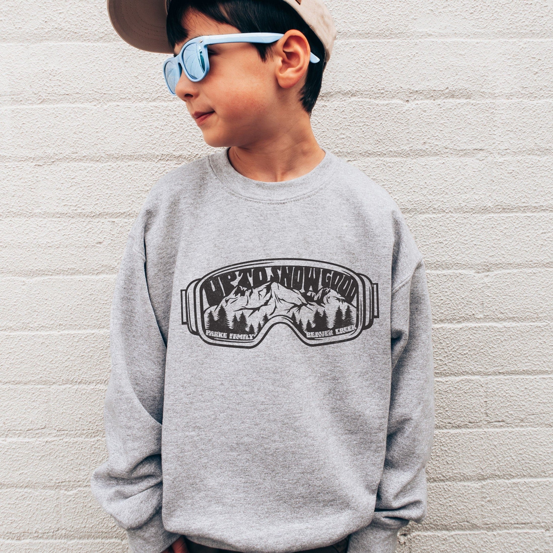 boy wearing Custom matching family ski trip sweatshirt with funny Up To Snow Good goggles design for group mountain weekend vacations shown in gray