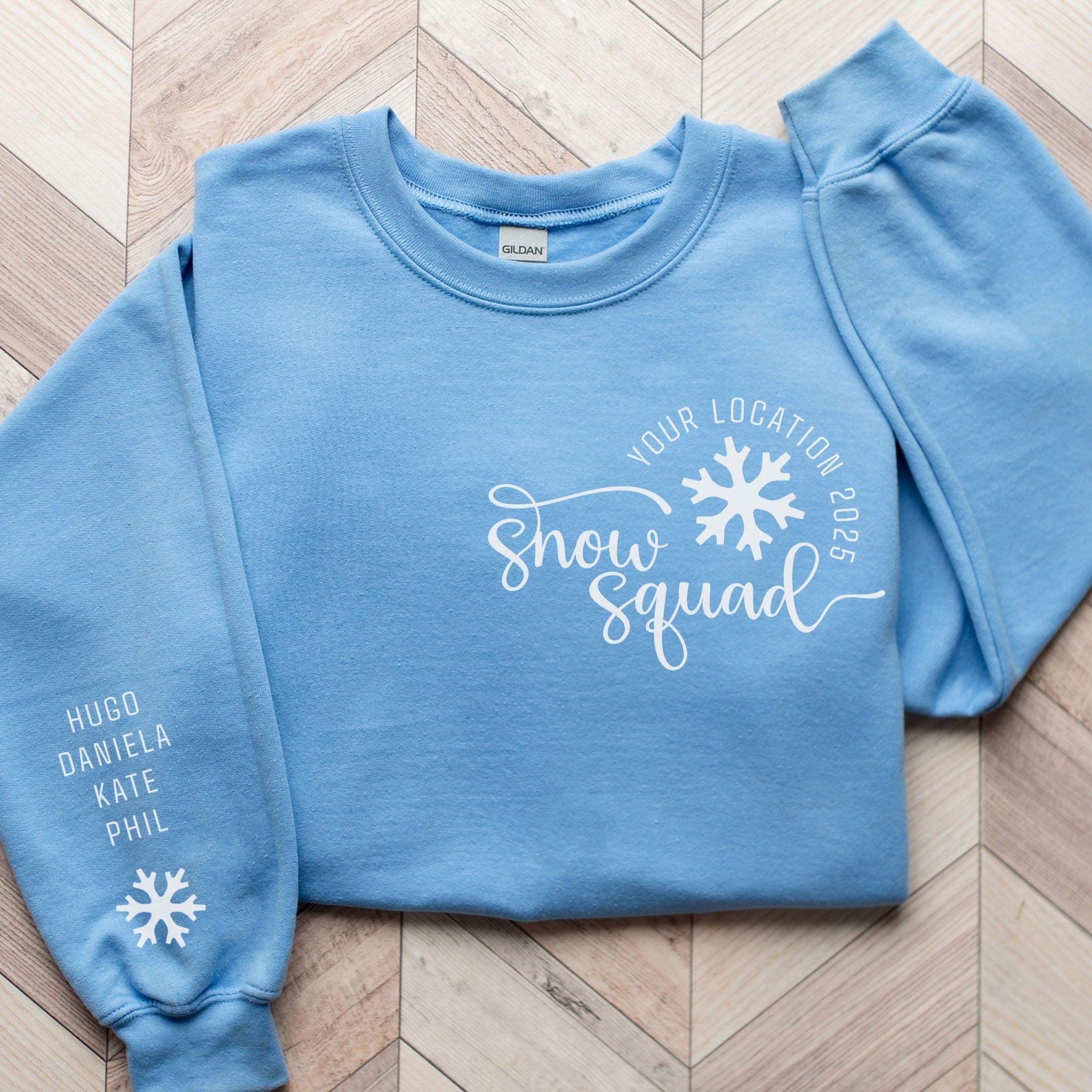 Custom matching family snow Squad sweatshirt for group ski weekend mountain vacation with sleeve print for names shown in carolina blue