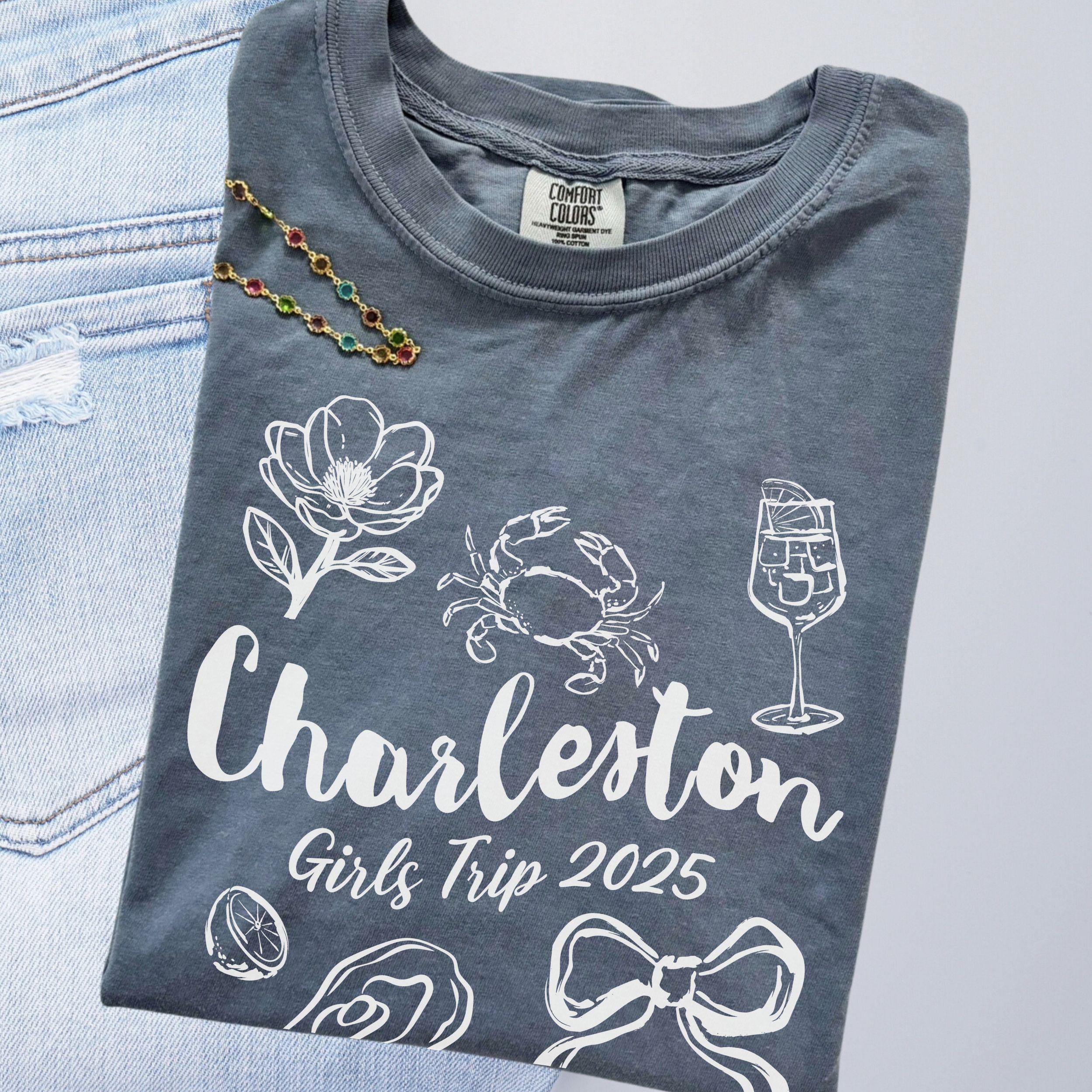 Charleston girls trip shirt with coquette bow and travel doodle design, printed on Comfort Colors Blue Jean for matching group vacations