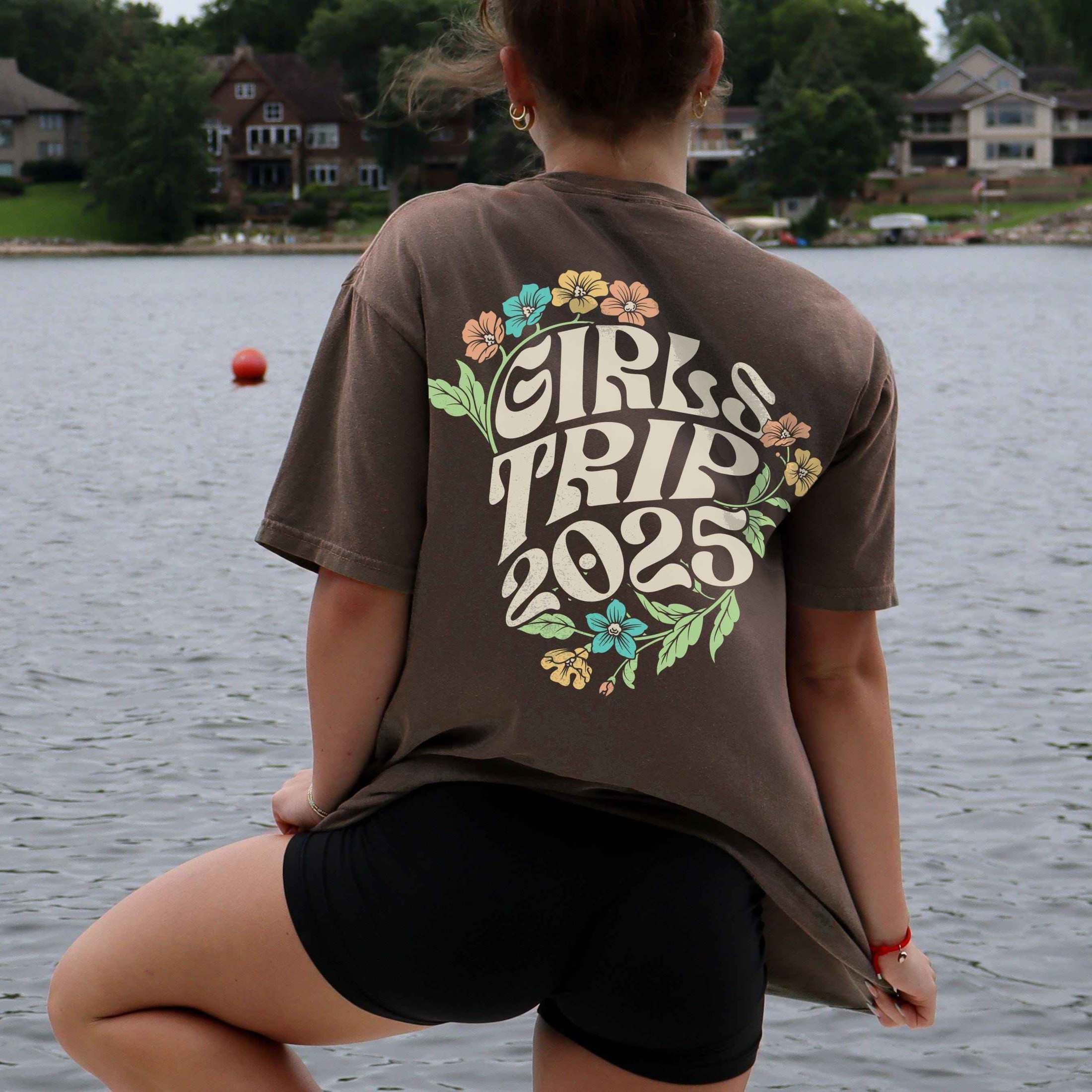 Woman wearing custom matching 60s or 70s retro floral girls trip shirts for group vacation shown in Comfort Colors Espresso