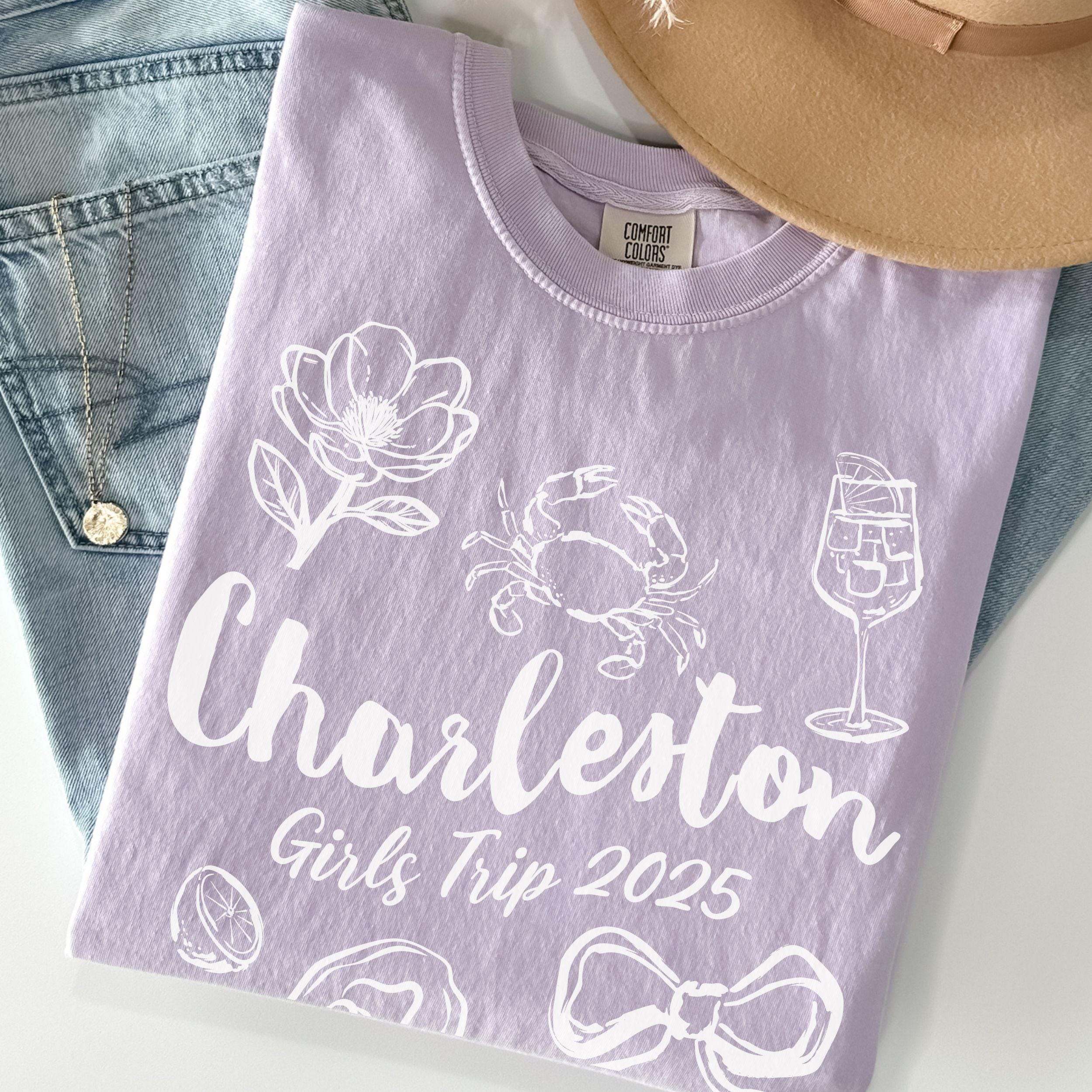 Charleston girls trip shirt with coquette bow and travel doodle design, printed on Comfort Colors Orchid for matching group vacations