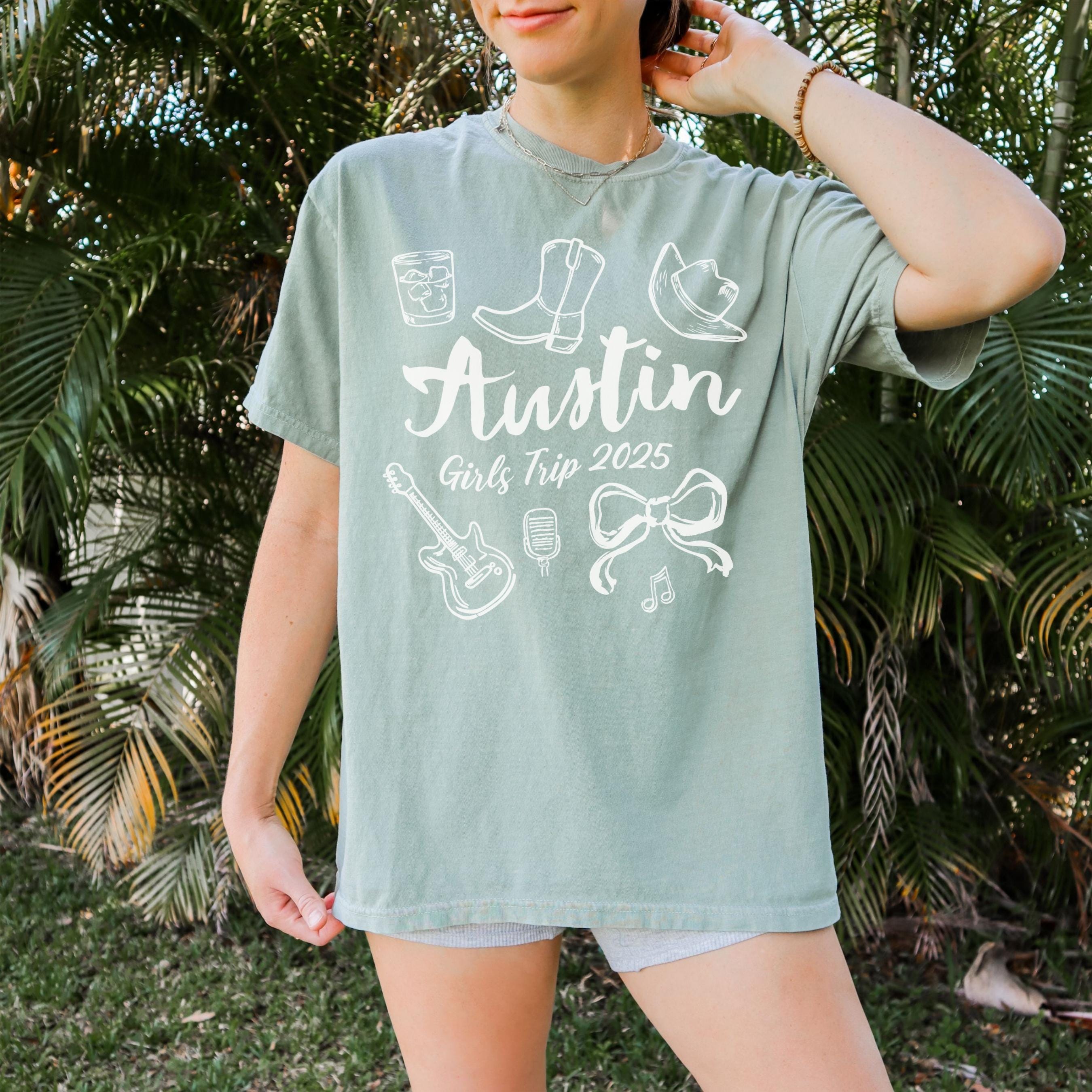 Austin girls trip shirt with coquette bow and travel doodle design, printed on Comfort Colors Bay for matching group vacations
