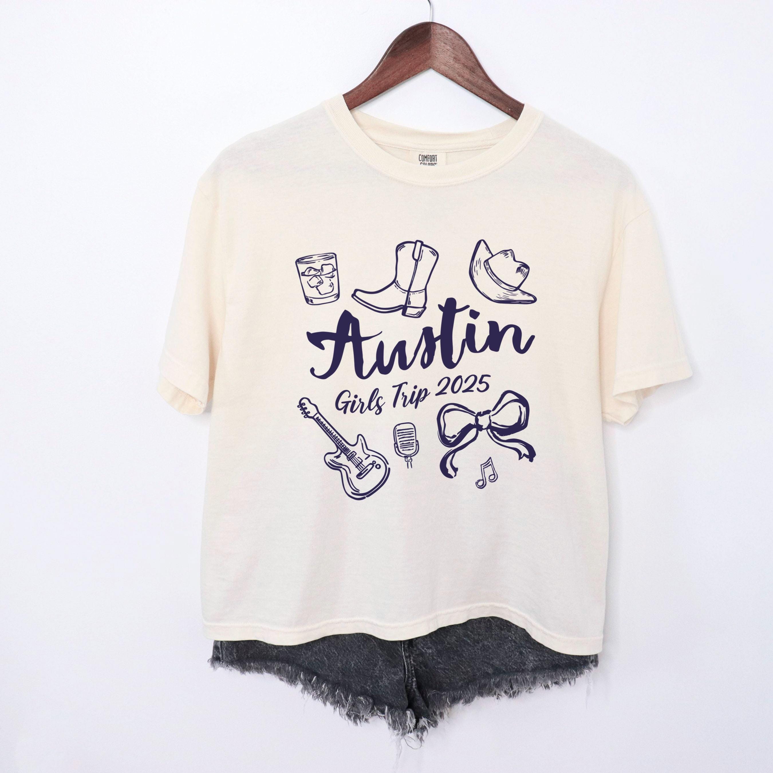 Austin girls trip shirt with coquette bow and travel doodle design, printed on Comfort Colors Ivory boxy tee crop for matching group vacations