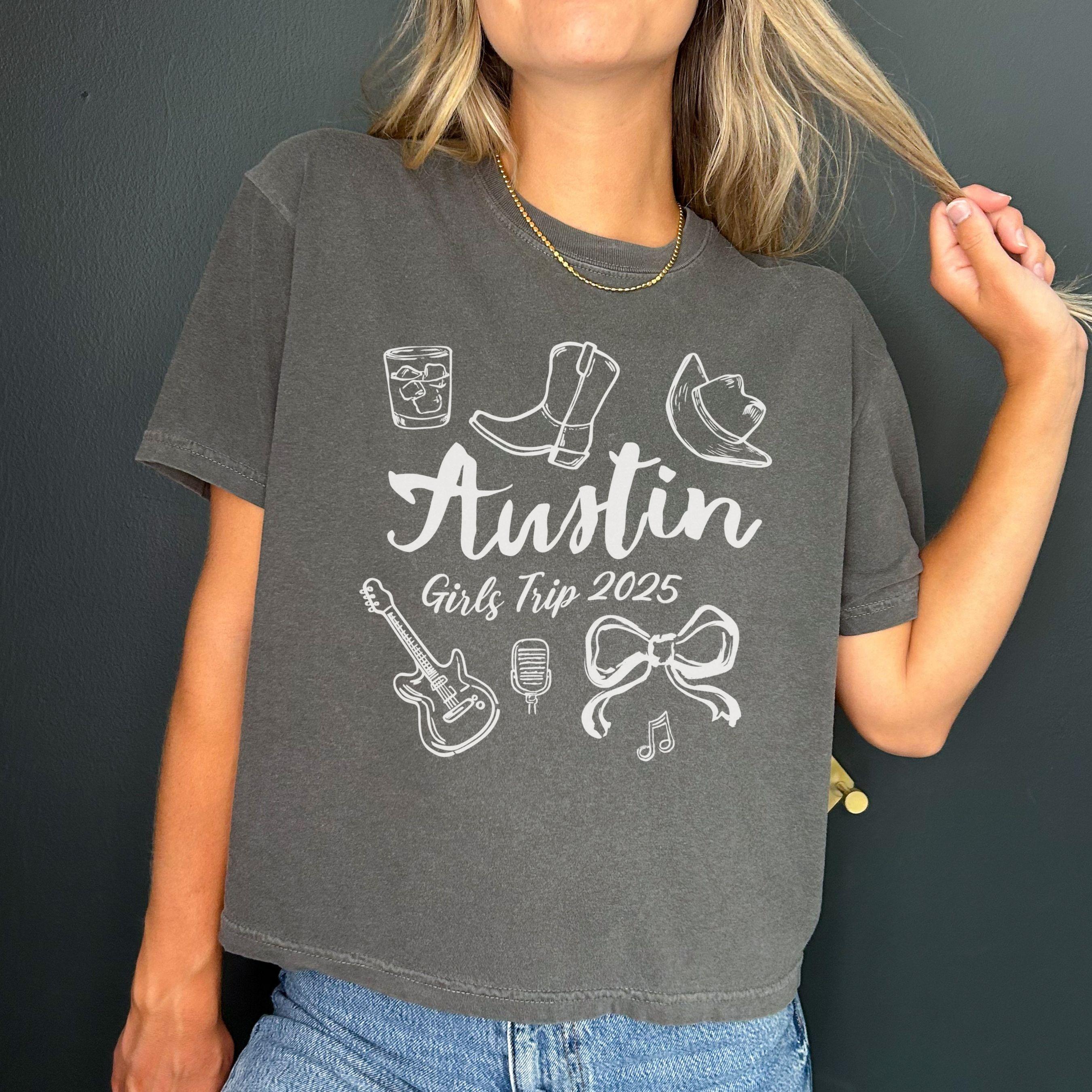 Austin girls trip shirt with coquette bow and travel doodle design, printed on Comfort Colors Pepper boxy crop tee for matching group vacations