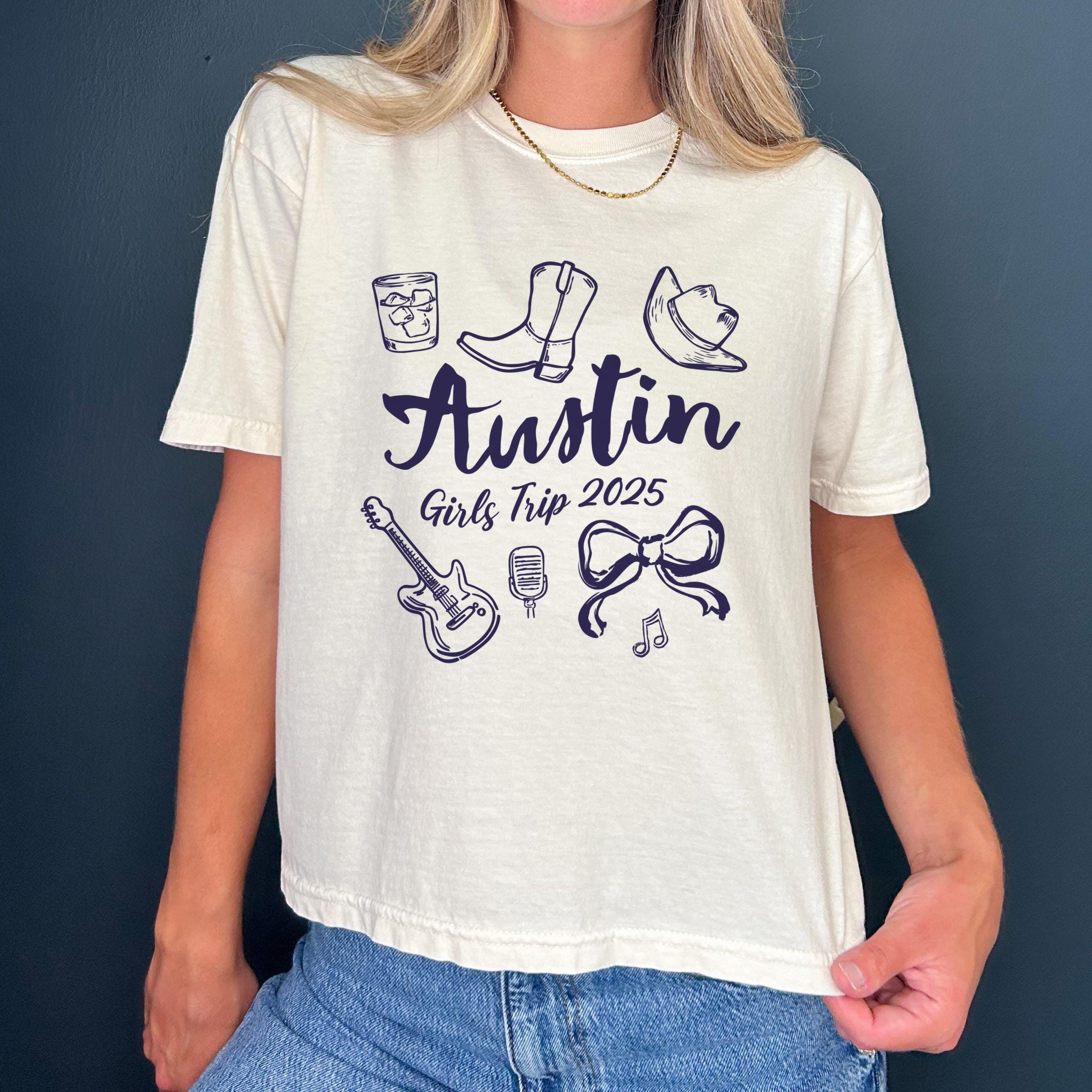 Austin girls trip shirt with coquette bow and travel doodle design, printed on Comfort Colors Ivory boxy crop tee for matching group vacations
