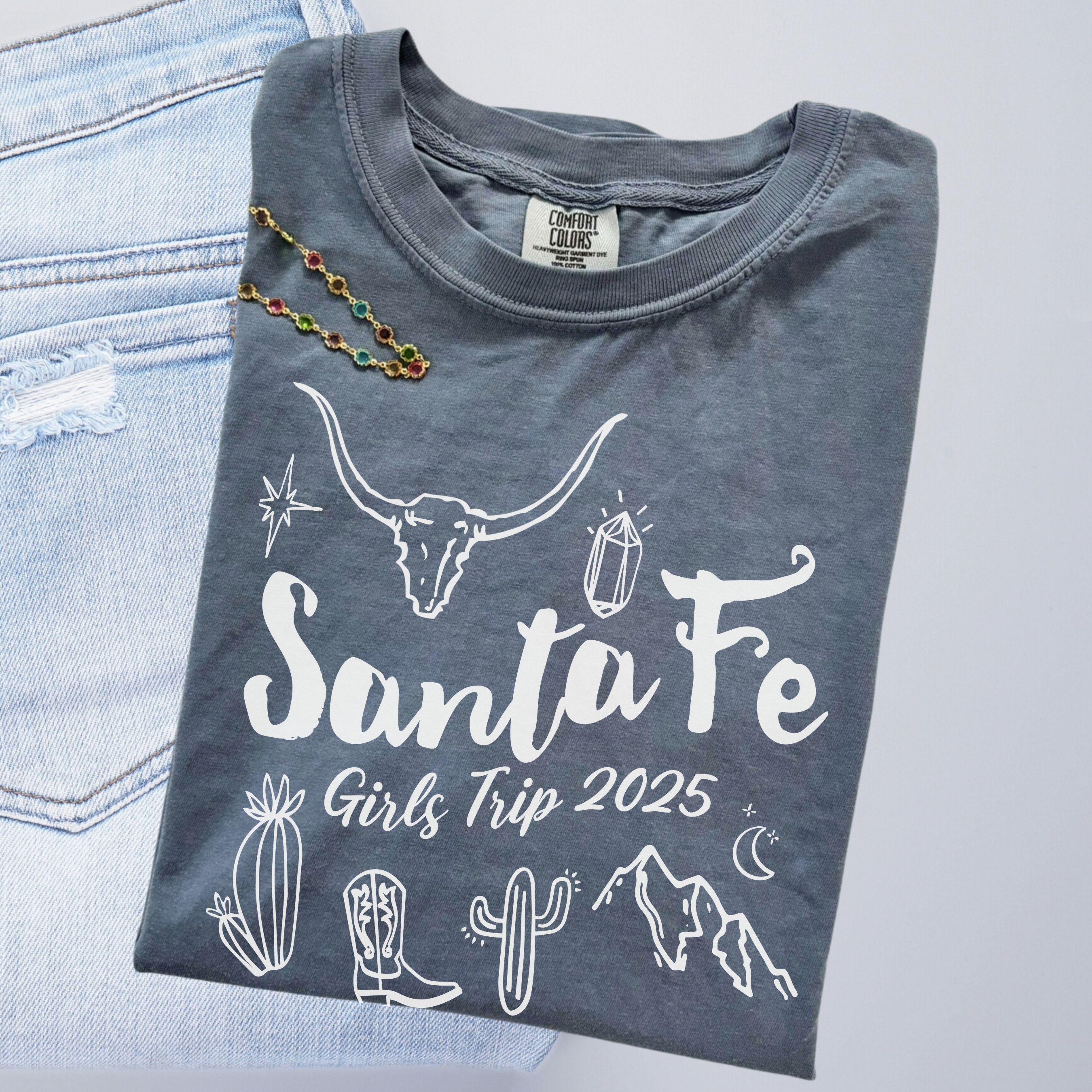 Matching Santa Fe desert girls weekend trip shirt with Western doodle design, featuring cactus and skull on Comfort Colors Blue Jean