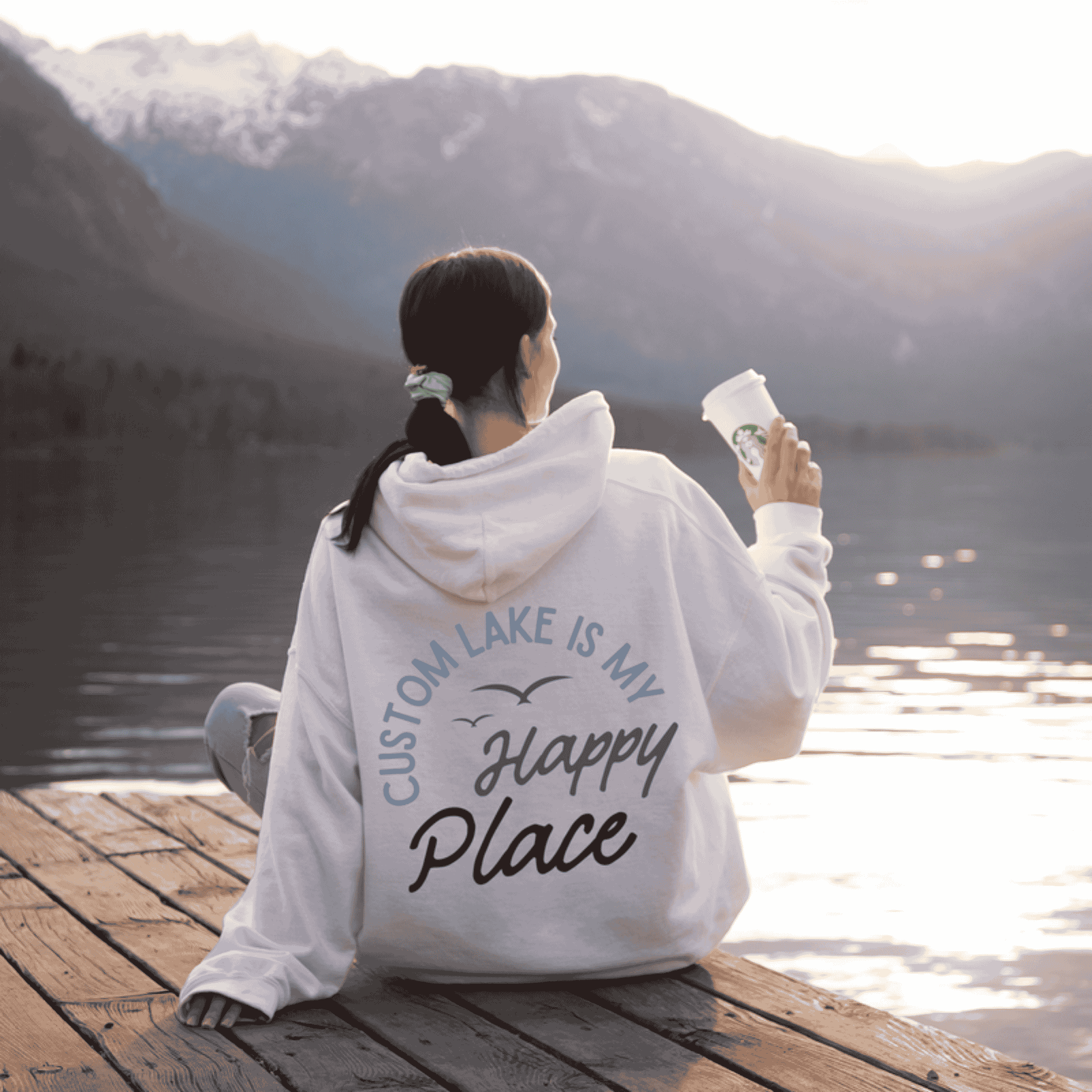 Woman wearing custom matching family Lake Is My Happy Place shirts personalized with name and year. Perfect for group lake vacations, shown on white hoodie