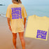 Woman wearing matching family vacation shirt with retro beach bums design in comfort colors butter