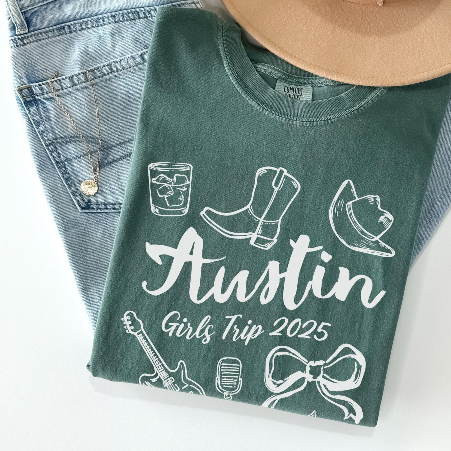 Austin girls trip shirt with coquette bow and travel doodle design, printed on Comfort Colors Blue Spruce for matching group vacations