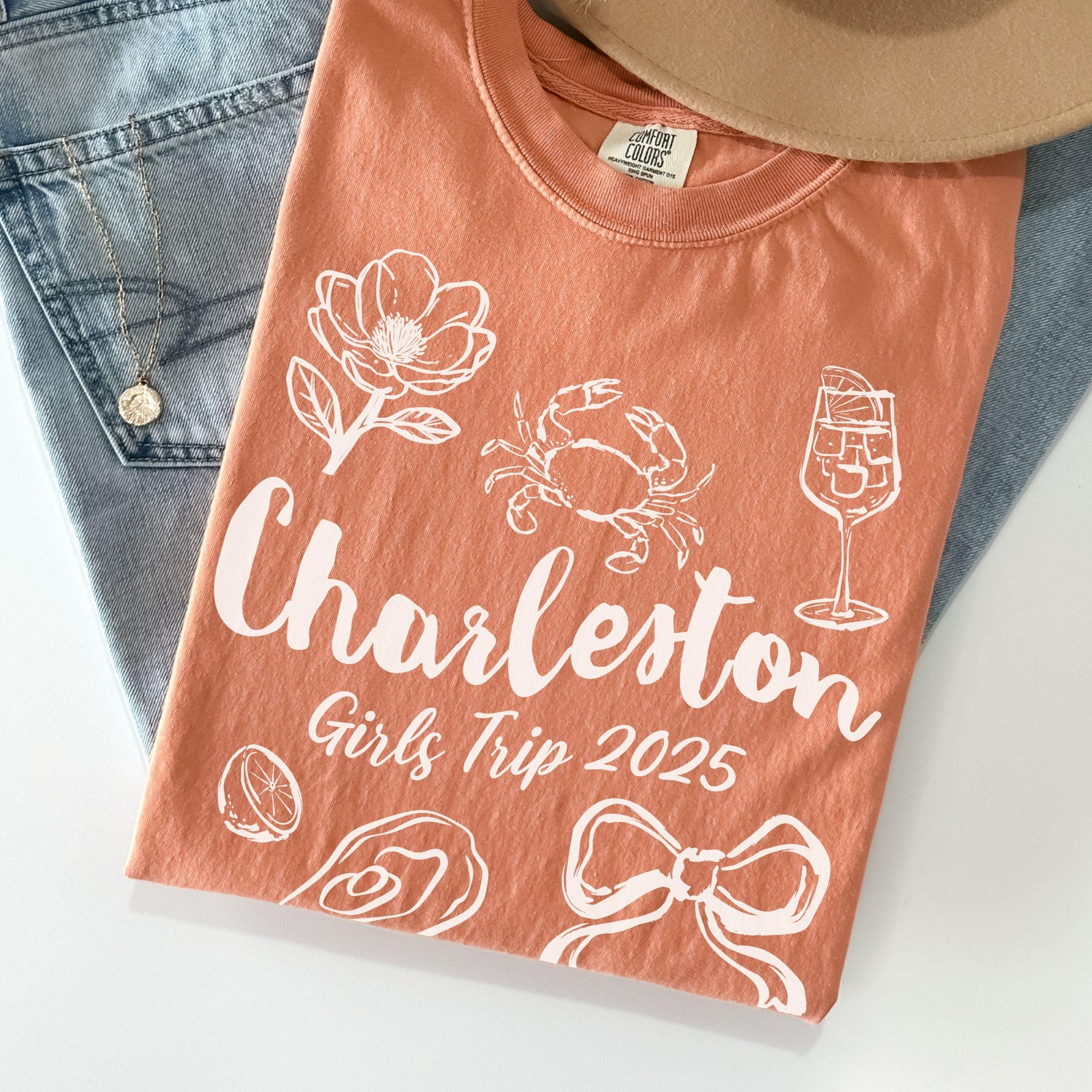 Charleston girls trip shirt with coquette bow and travel doodle design, printed on Comfort Colors Terracotta for matching group vacations