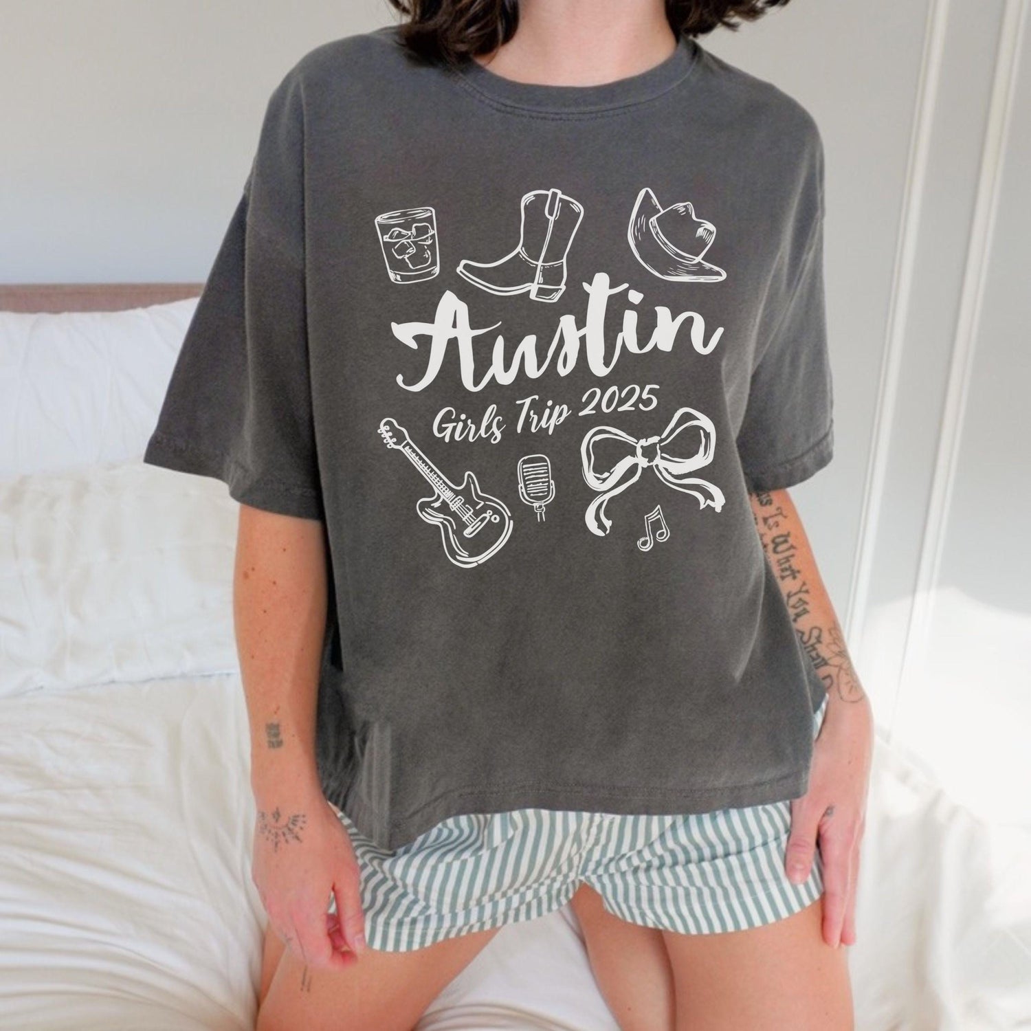 Austin girls trip shirt with coquette bow and travel doodle design, printed on Comfort Colors Pepper Boxy tee crop for matching group vacations