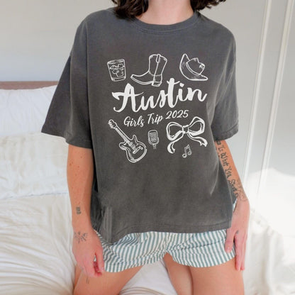 Austin girls trip shirt with coquette bow and travel doodle design, printed on Comfort Colors Pepper Boxy tee crop for matching group vacations