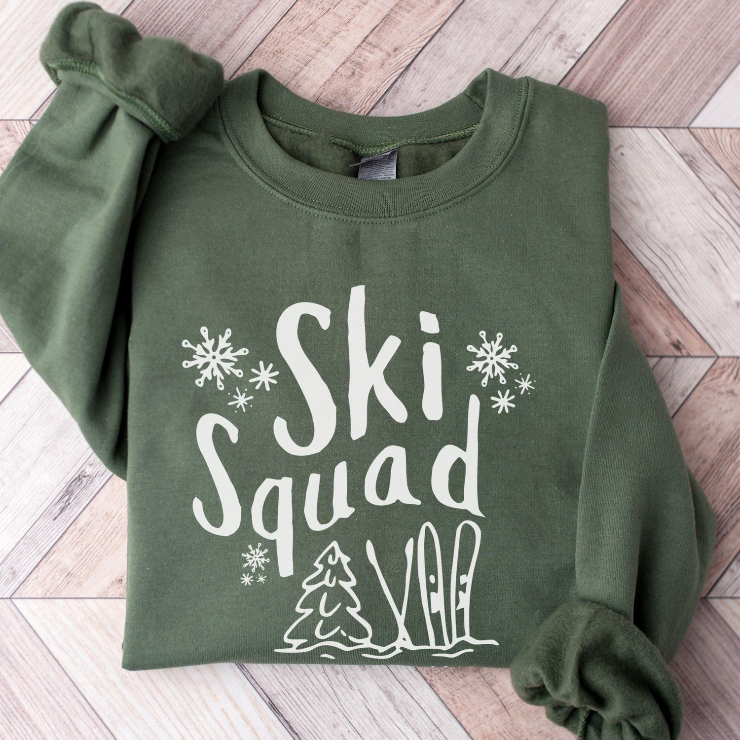 Custom Ski Squad sweatshirt with winter snow doodle design, perfect for matching family or group ski trip. Shown in Military Green