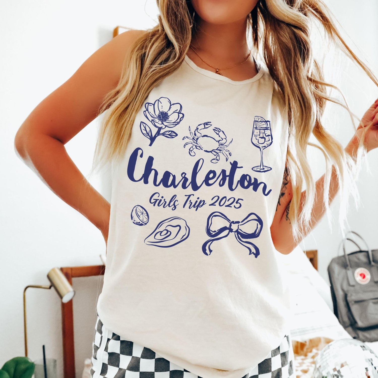 Charleston girls trip shirt with coquette bow and travel doodle design, printed on Comfort Colors Ivory tank for matching group vacations