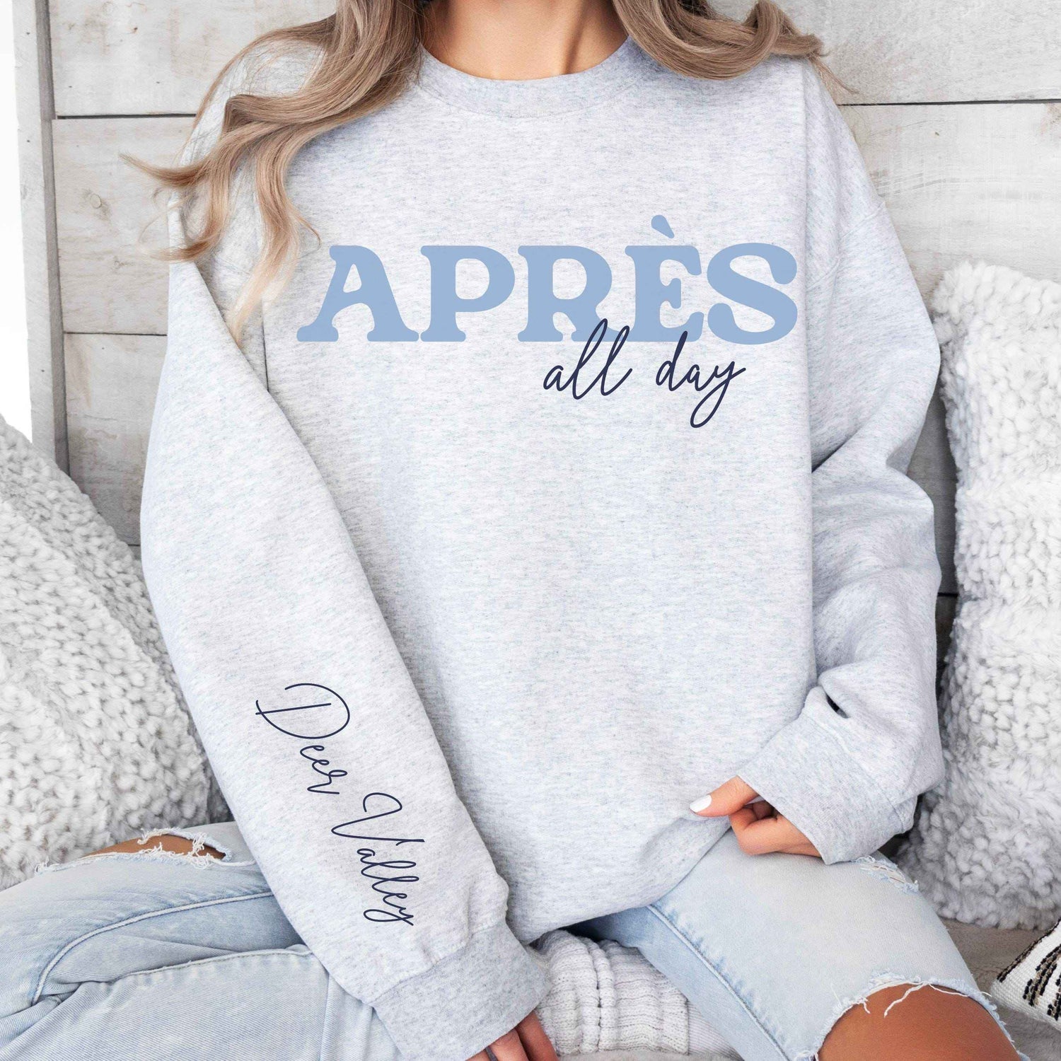 Woman wearing a custom matching group vacation retro style Apres Ski all day sweatshirt with sleeve print in Ash
