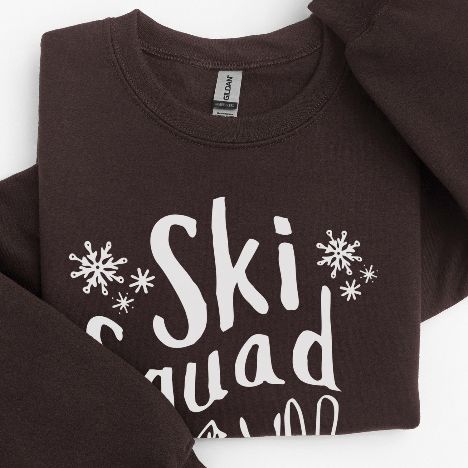 Custom Ski Squad sweatshirt with winter snow doodle design, perfect for matching family or group ski trip. Shown in Dark Chocolate