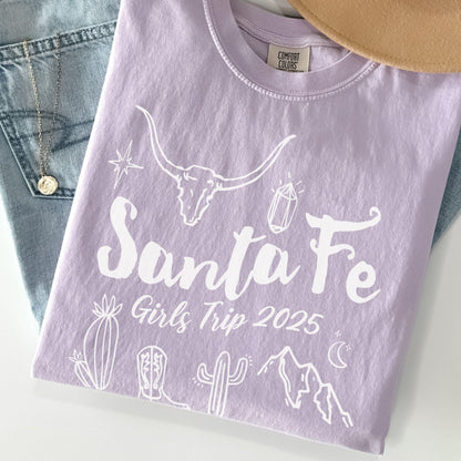 Matching Santa Fe desert girls weekend trip shirt with Western doodle design, featuring cactus and skull on Comfort Colors Orchid