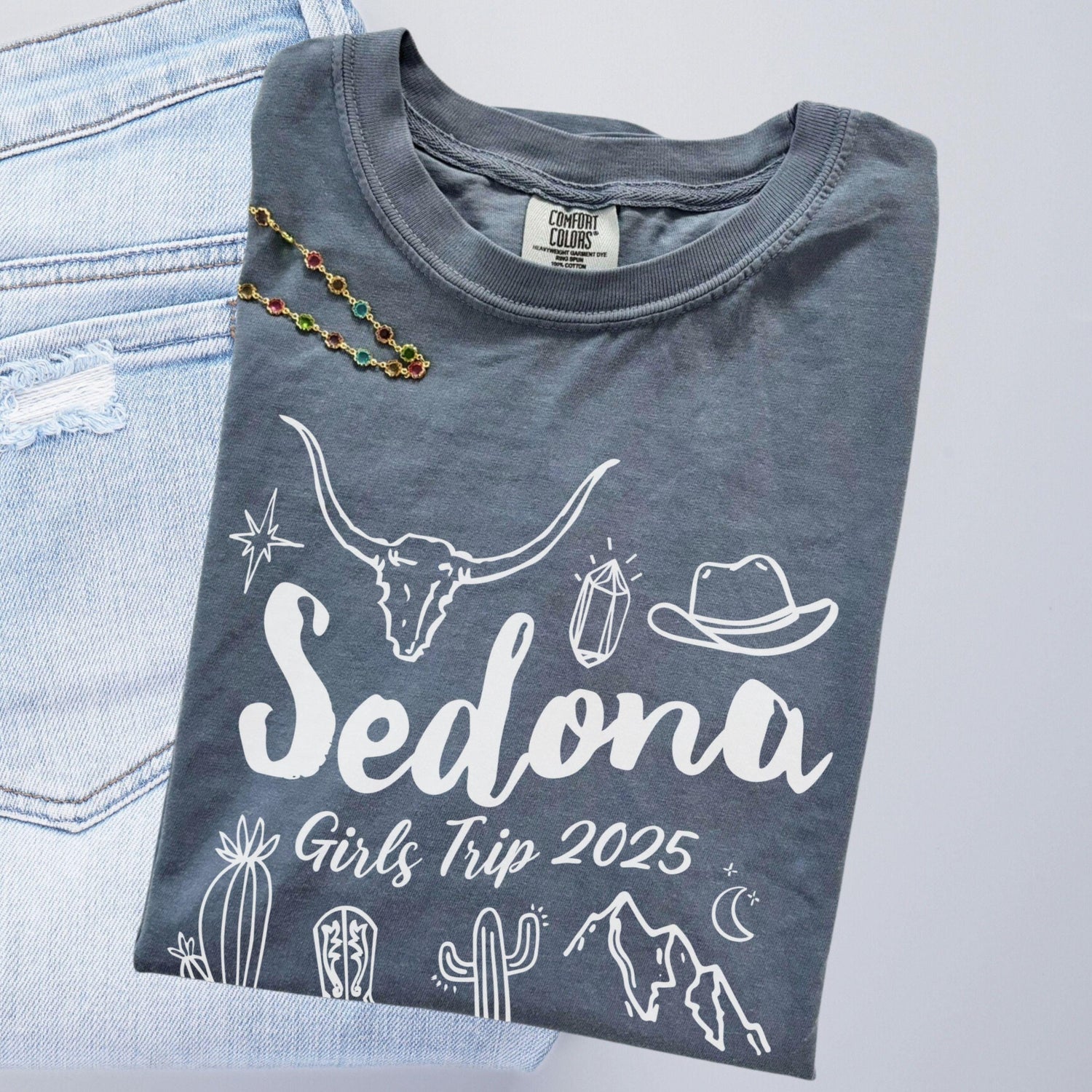 Matching Sedona Arizona desert girls weekend trip shirt with Western doodle design, featuring cactus and skull on Comfort Colors Blue Jean